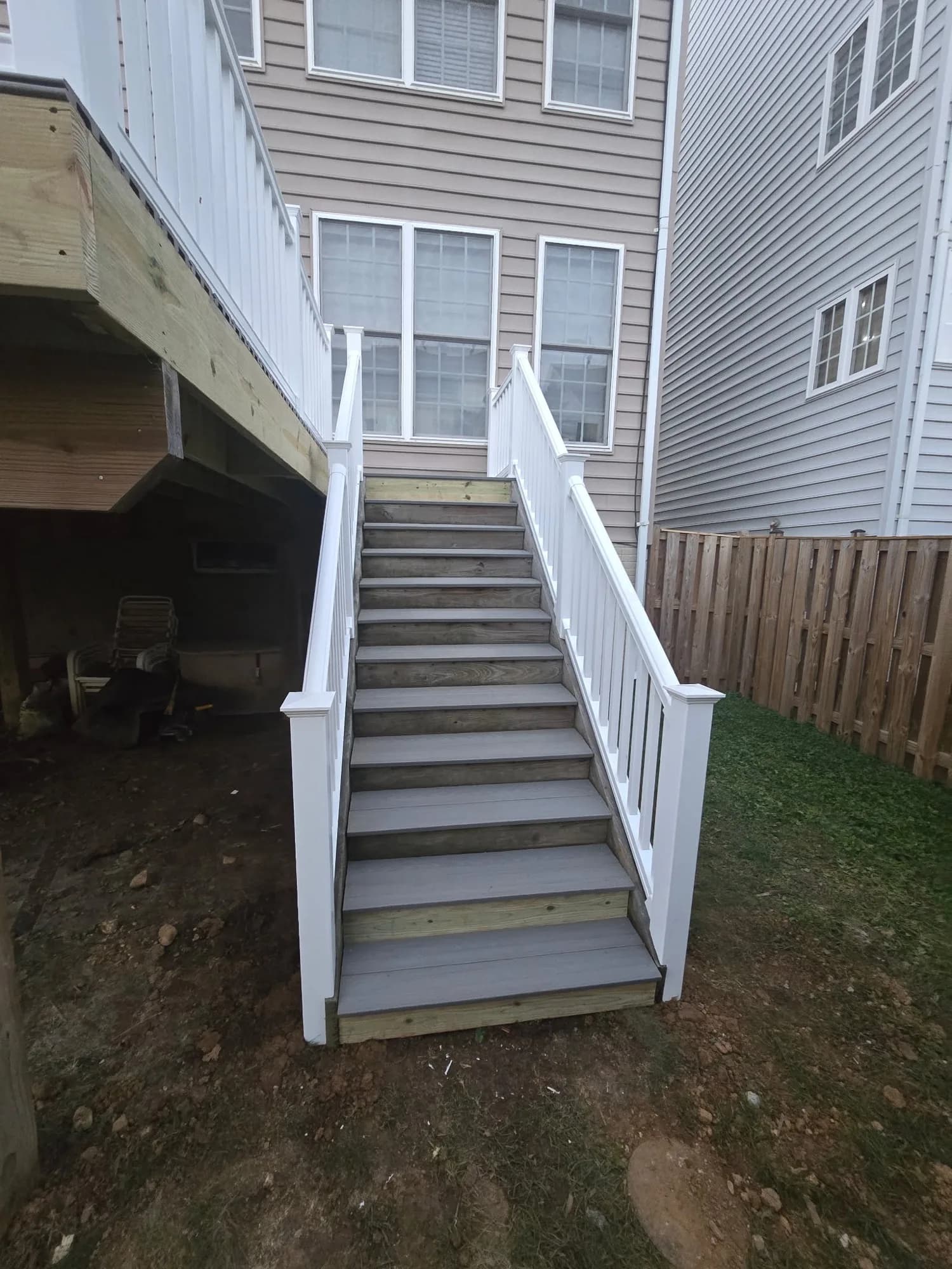 New composite deck stairs with white vinyl railing — completed by Local Expert Handyman