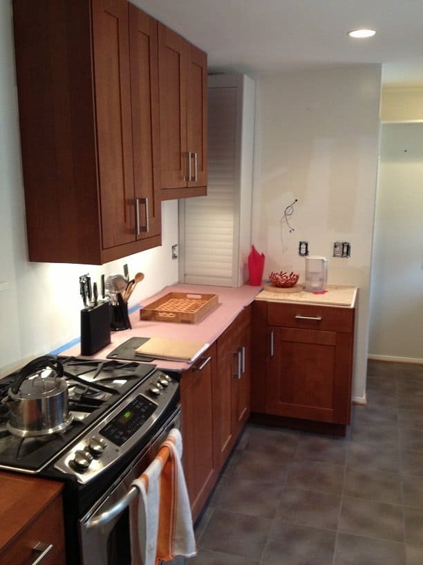 Kitchen remodeling with new wooden cabinets and modern appliances.
