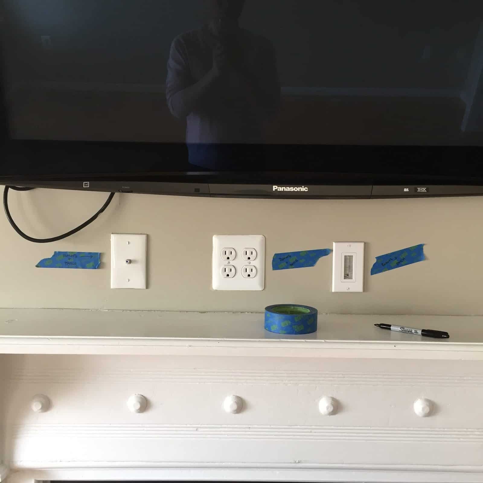 Handyman fixing interior door with tools and tape for a smooth finish.