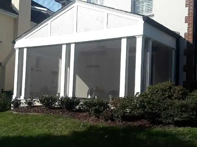 Well-maintained screened porch for outdoor relaxation and protection from insects.